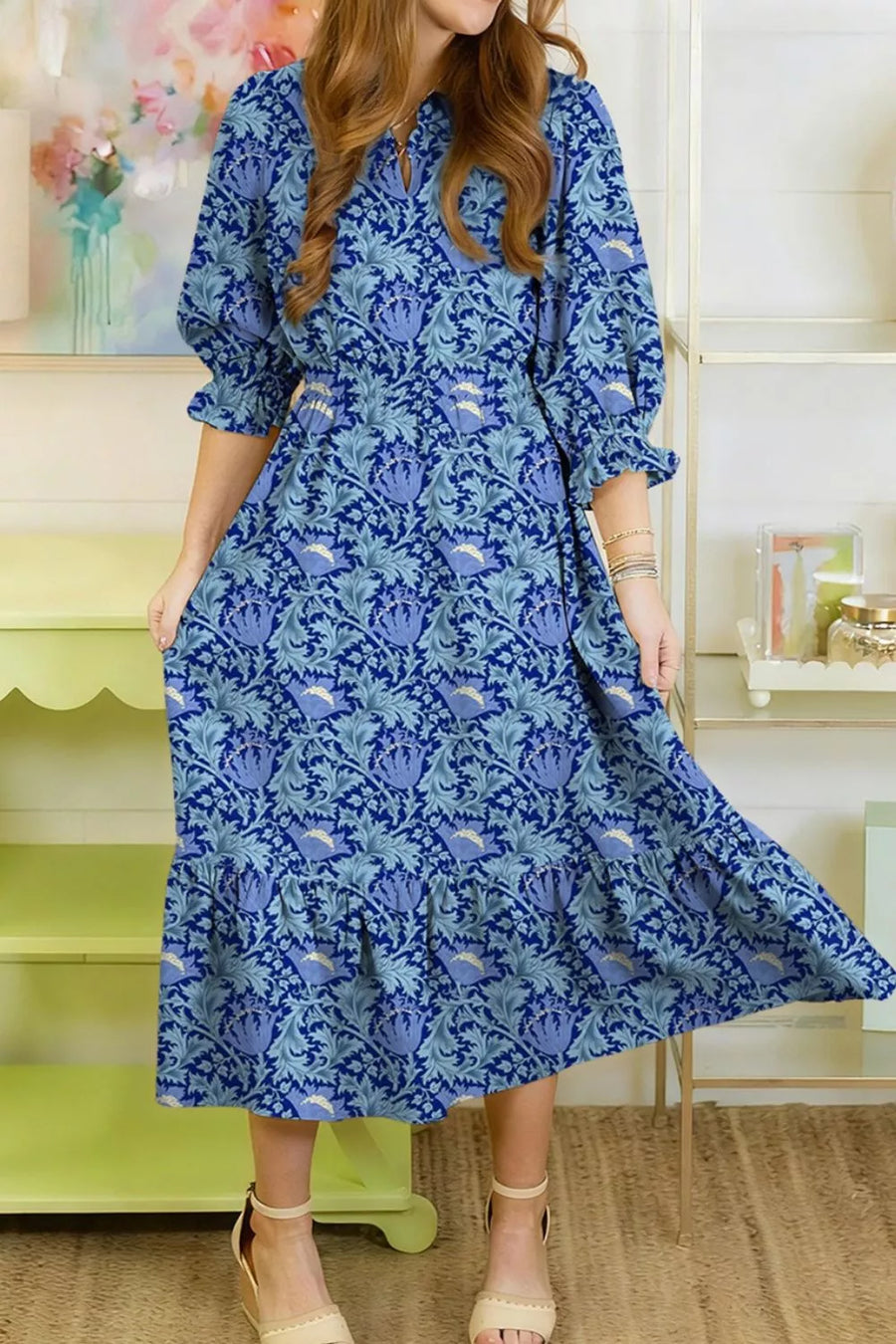 Blue floral cotton midi dress with cinched waist, frilled cuffs and tiered hem.