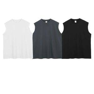 Sleeveless asymmetric panel tank tops in black, white, and dark gray.