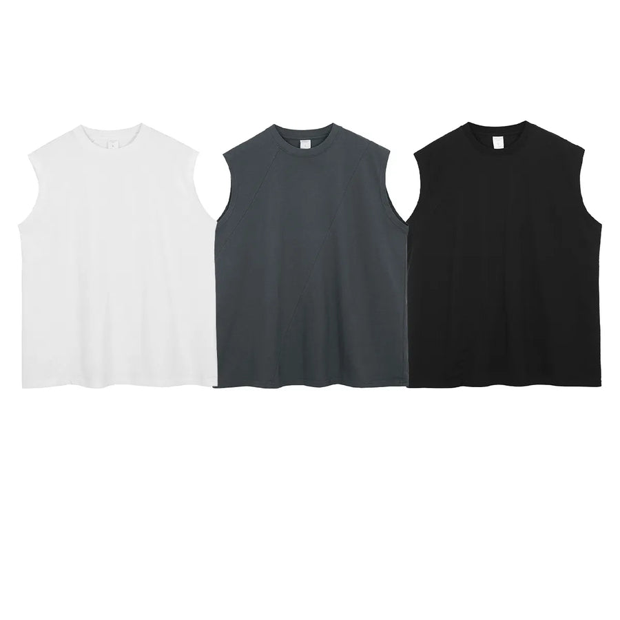 Sleeveless asymmetric panel tank tops in black, white, and dark gray.