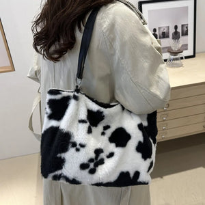 Cowhide print faux fur shopper bag with black straps.