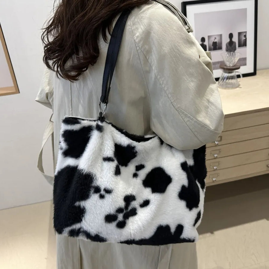 Cowhide print faux fur shopper bag with black straps.