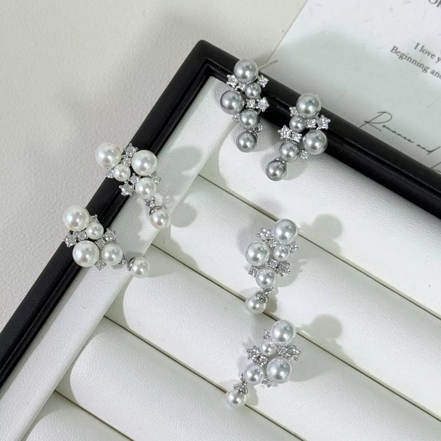 Sophisticated pearl and zircon cluster earrings in light gray and white.