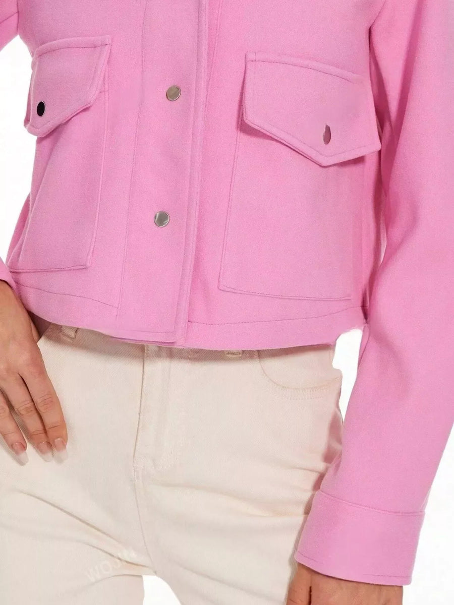 Pink trucker jacket with snap buttons and chest pockets.