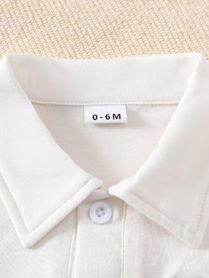White cotton baby outfit with collar and button detail, size 0-6M.