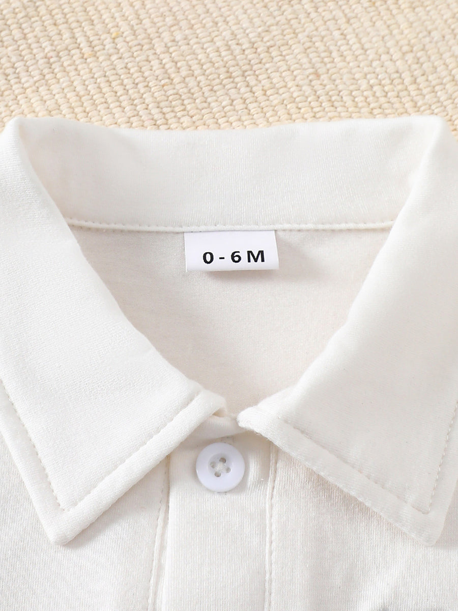 White cotton baby outfit with collar and button detail, size 0-6M.