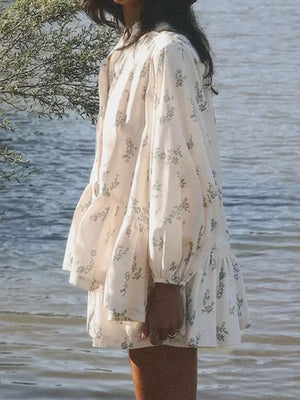 Cream floral print mini dress with puff sleeves and tiered ruffle hem.
