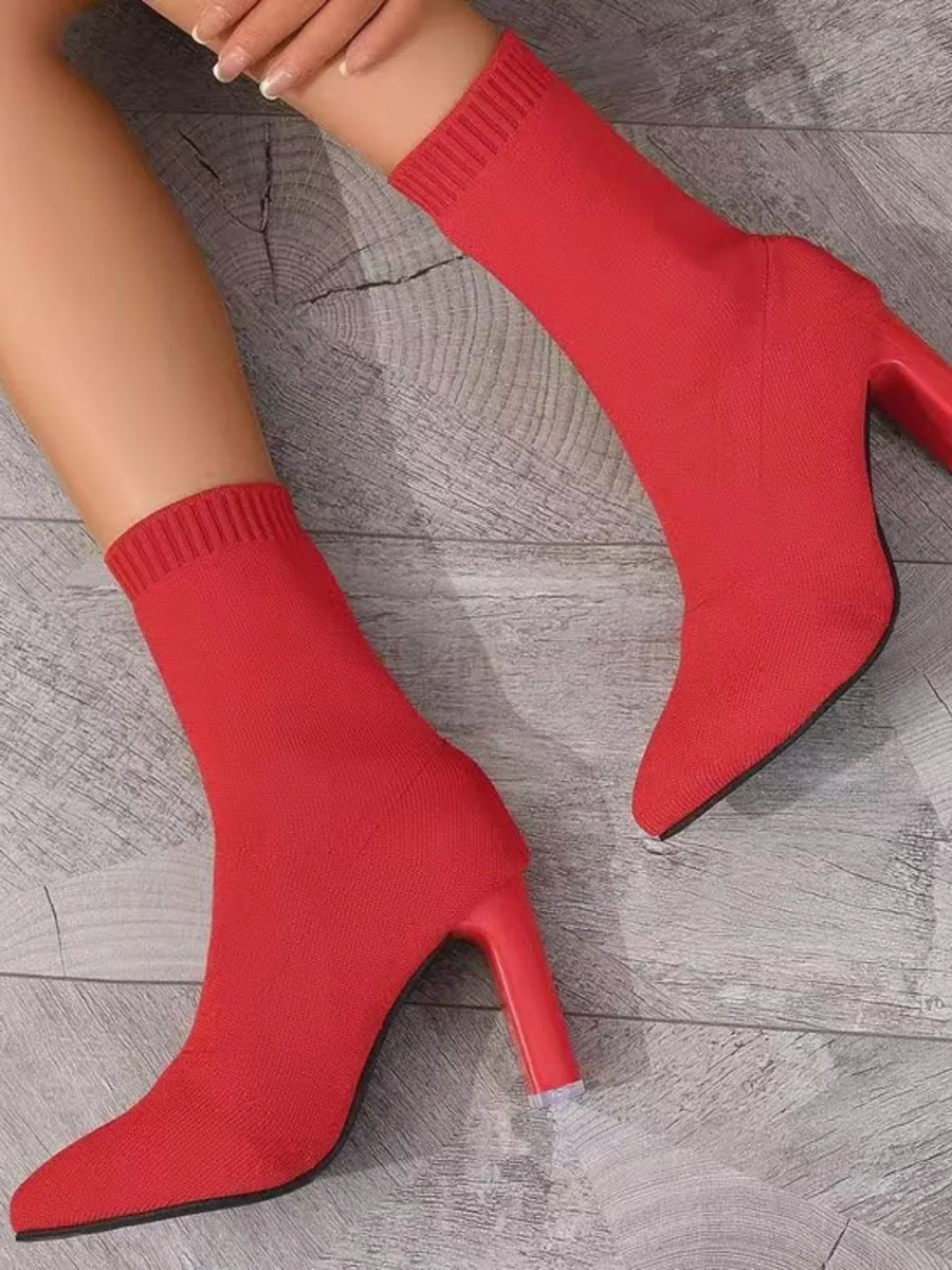 Red knit sock booties with sculpted heel and pointed toe.