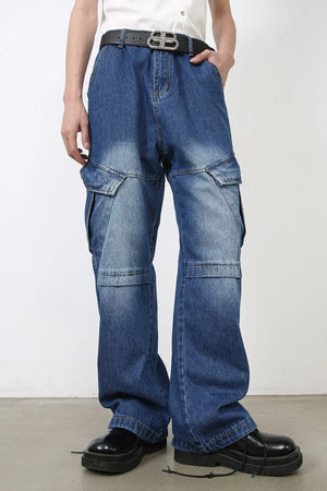 Cargo denim flare trousers in medium wash blue with multiple pockets and a relaxed fit.