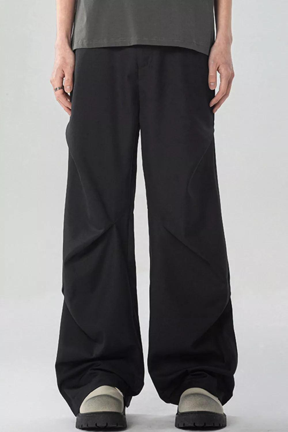 Men's black wide-leg sweatpants with pockets and a relaxed fit.