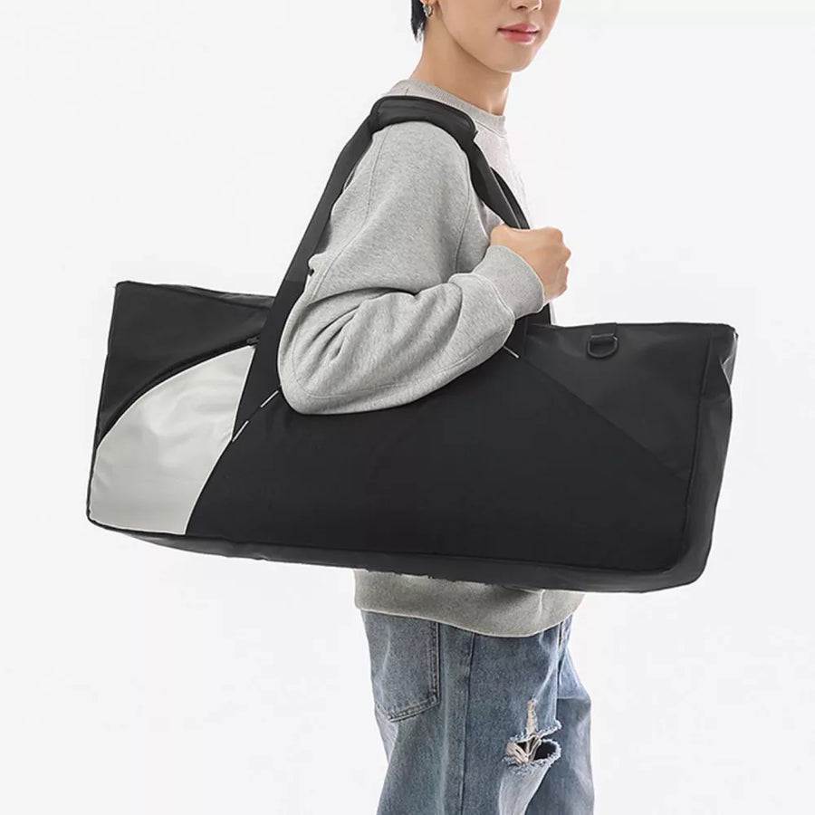 Black and silver color block travel organizer bag with shoulder strap.