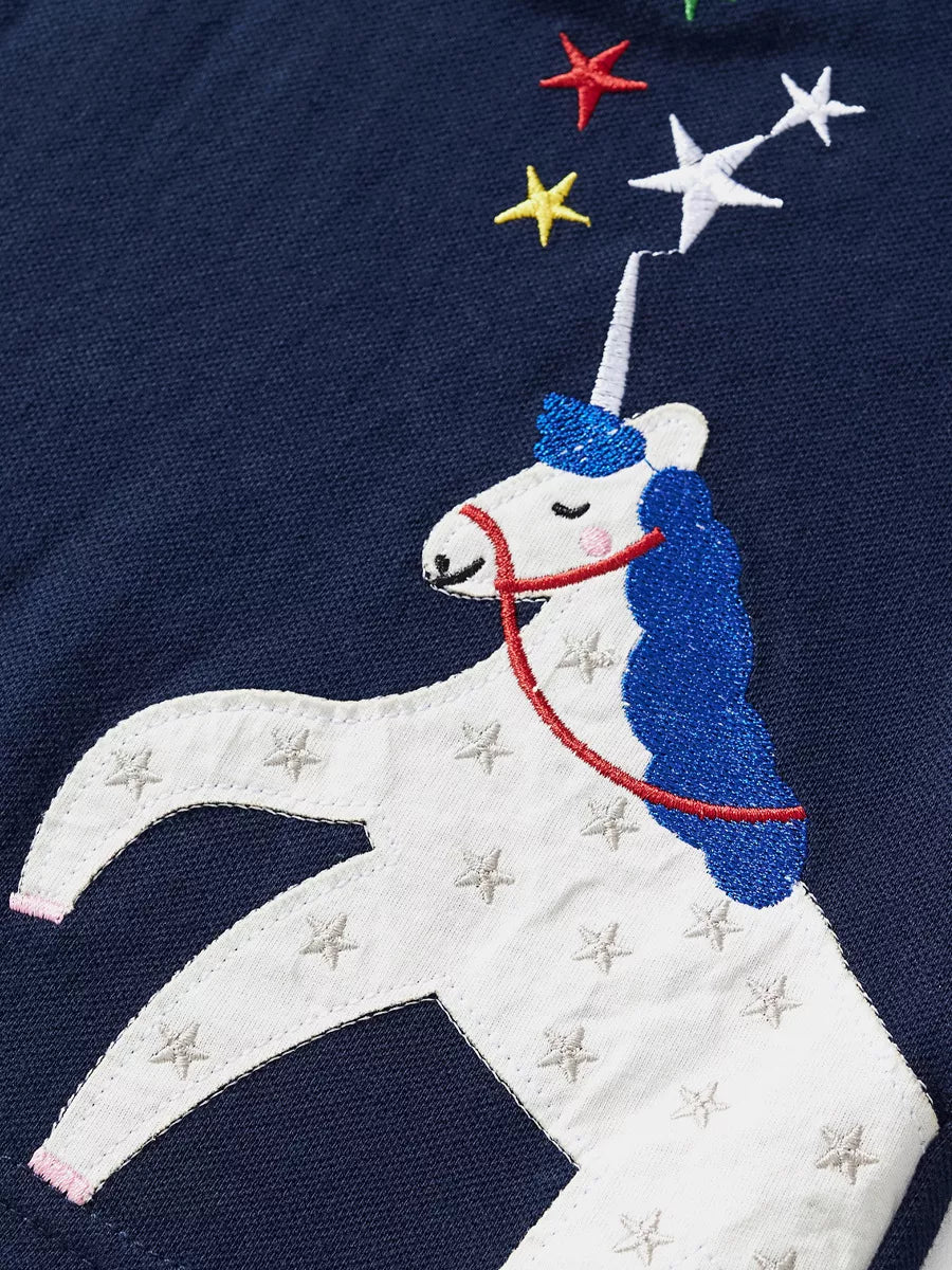 Navy blue sweatshirt with embroidered white unicorn and colorful stars.