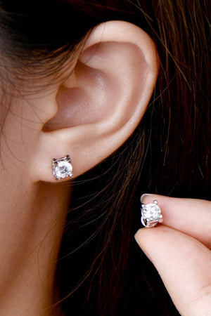 Rose gold moissanite solitaire stud earrings with a four-prong setting.