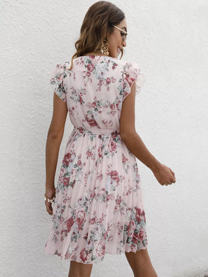 Blush pink floral pleated dress with ruffle sleeves and a belt.