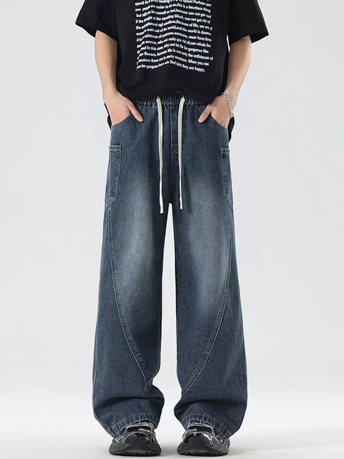 Oversized wide-leg jeans in blue denim with a drawstring waist and vintage-inspired paneling.