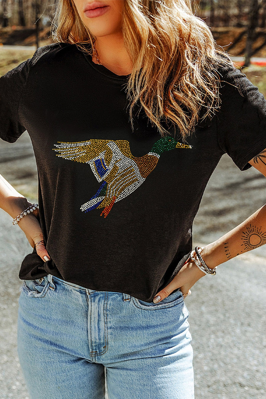 gold t-shirt featuring rhinestone embellishment and animal graphic