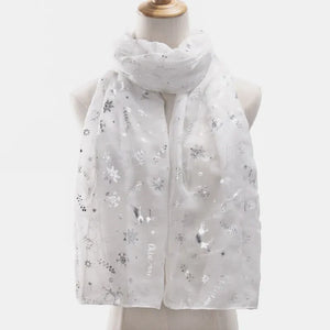 White Christmas print metallic scarf with snowflakes and reindeer.