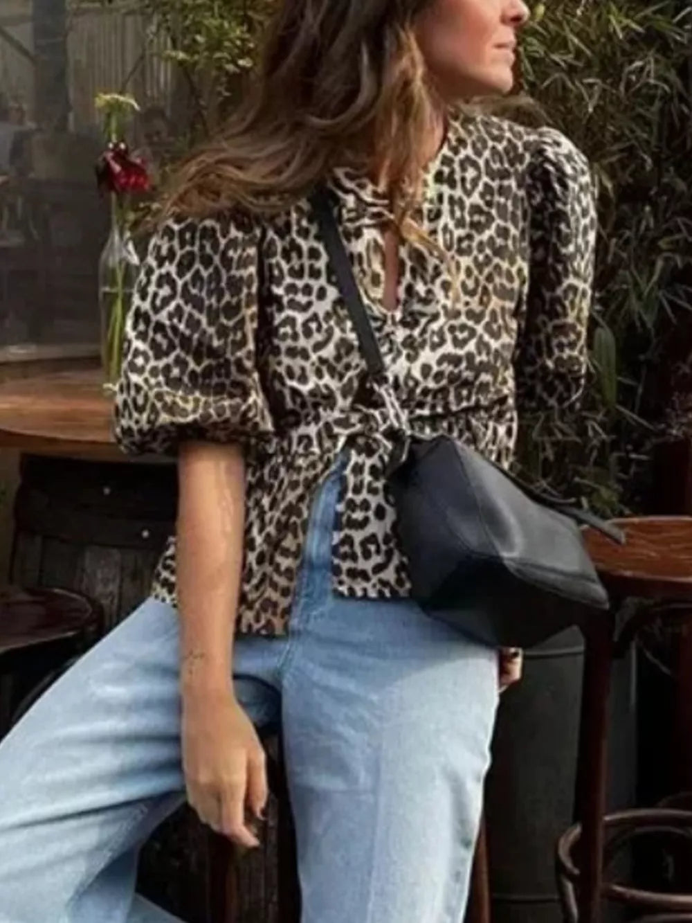 black blouse featuring puff sleeves and leopard