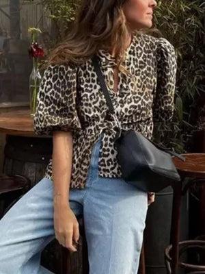 black blouse featuring puff sleeves and leopard