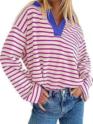 Oversized striped long-sleeve sweatshirt with v-neck collar in cream and magenta stripes.