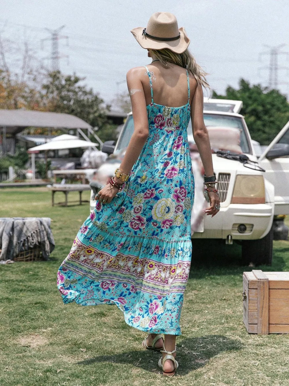 Turquoise floral tiered cami maxi dress with tassel detail and a bohemian print.