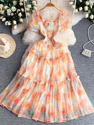 Floral tiered midi dress with smocked bodice and puff sleeves in a watercolor floral print.