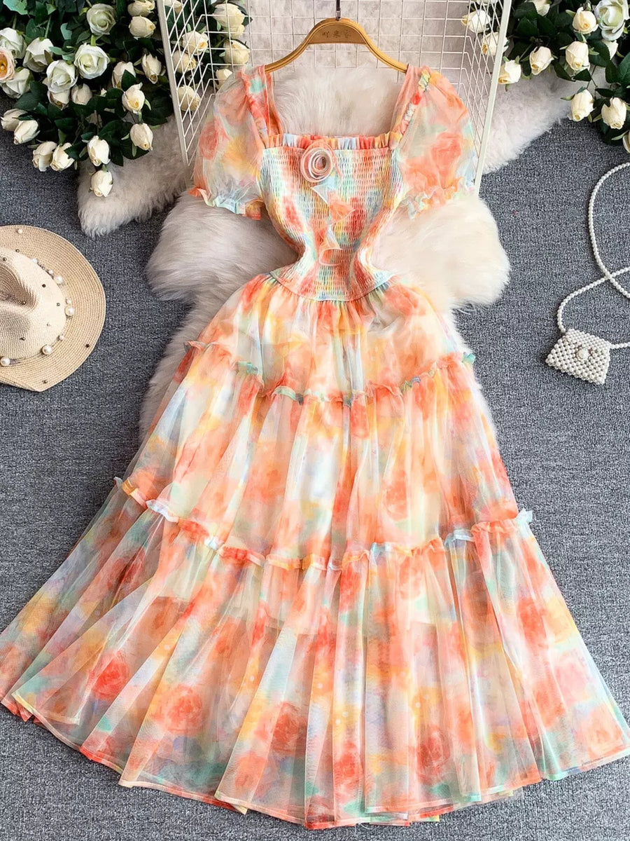 Floral tiered midi dress with smocked bodice and puff sleeves in a watercolor floral print.