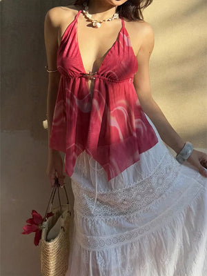 Backless halter neck cami in pink abstract print with hook-and-eye closure.