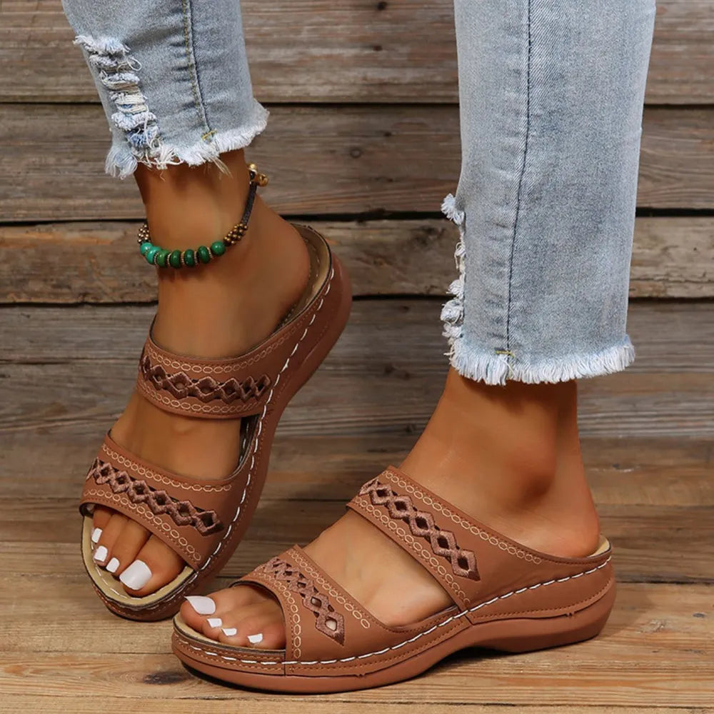 Embroidered strap comfort slides in caramel with a contoured sole.
