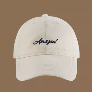 Cream white cotton baseball cap with embroidered "Amazed" text