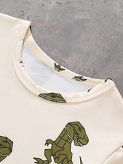Cream cotton tee with green geometric dinosaur print, crew neck.
