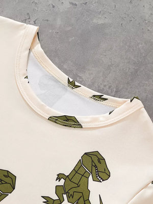 Cream cotton tee with green geometric dinosaur print, crew neck.
