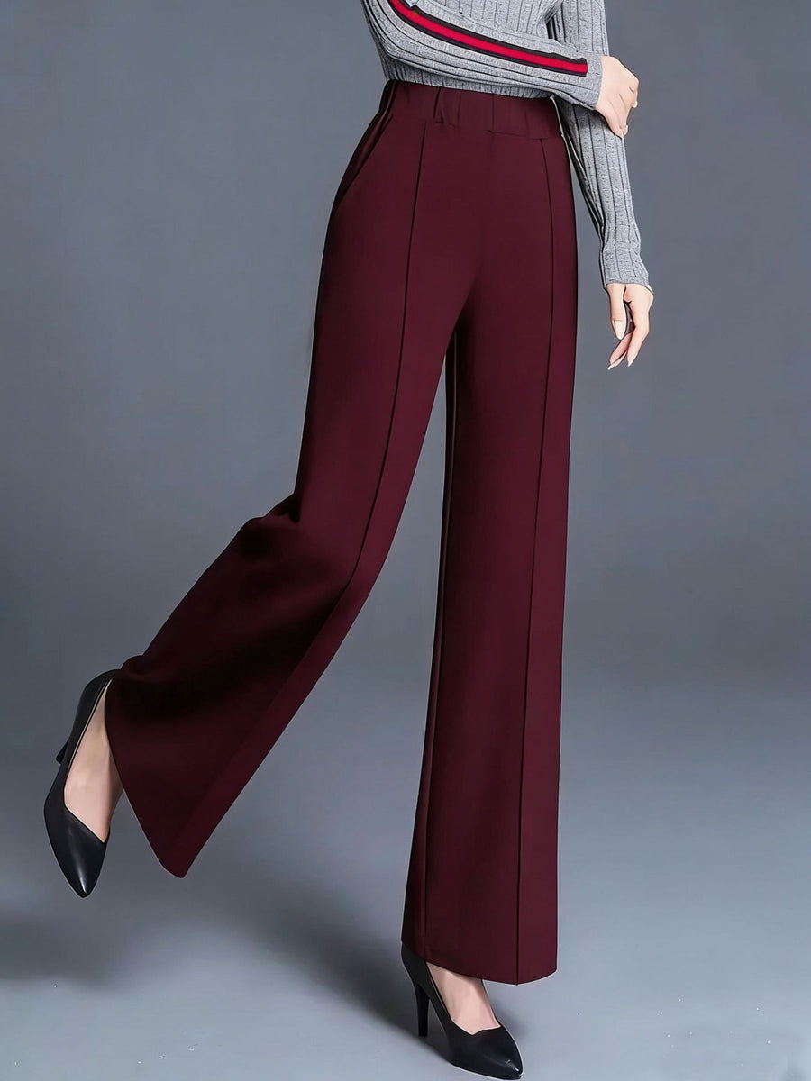 Burgundy high-waisted wide leg trousers with pockets and front seam detail.