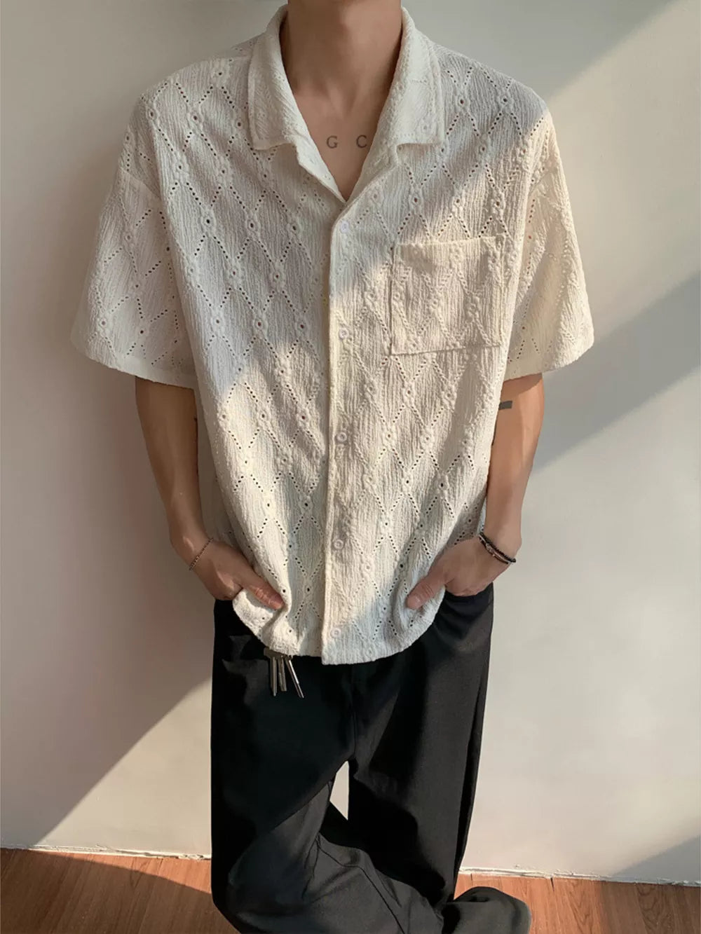 White textured knit short-sleeve men's shirt with diamond pattern and button front.