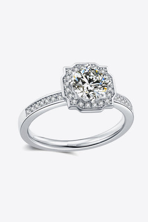 Silver halo engagement ring with a central round diamond and pavé band.