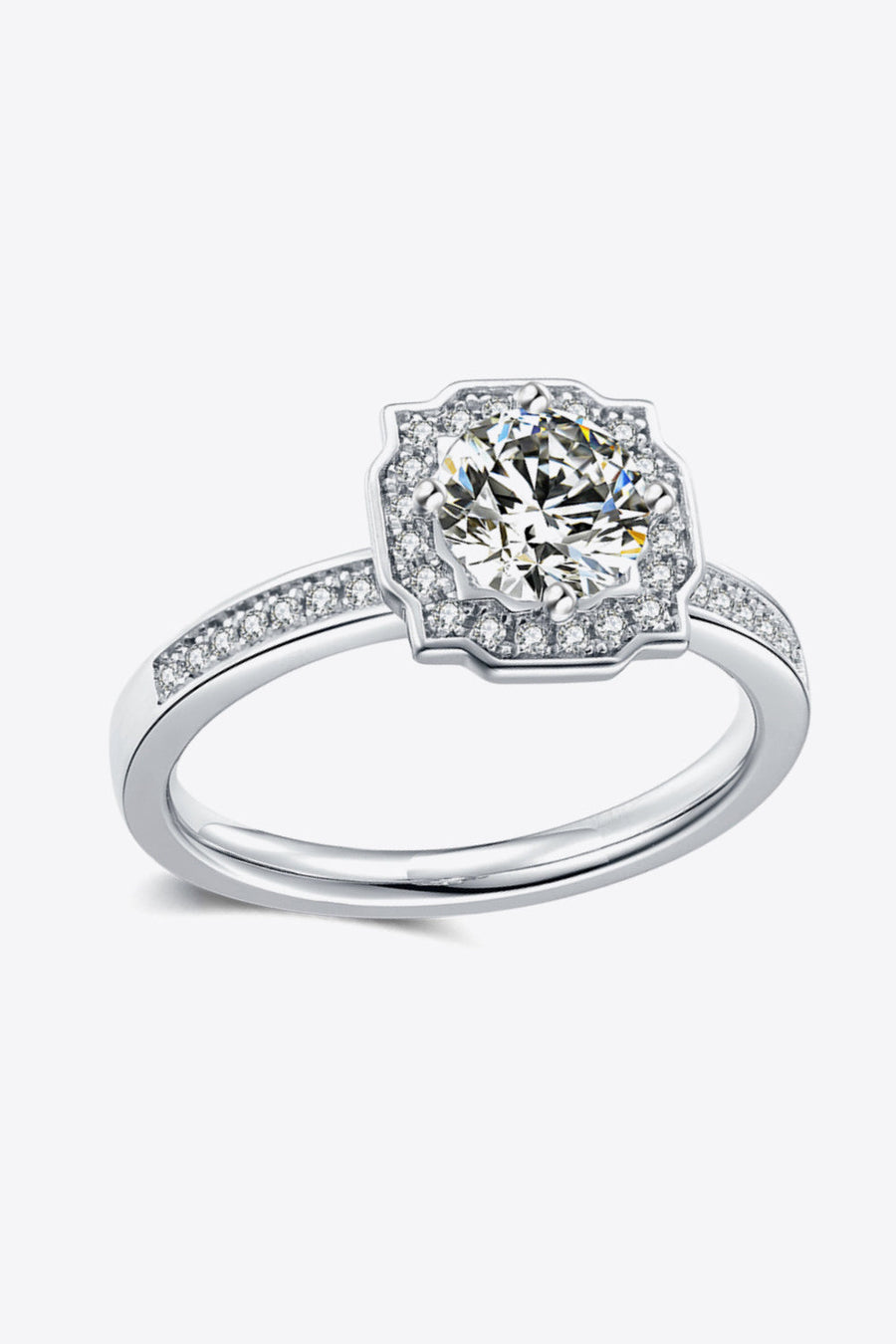 Silver halo engagement ring with a central round diamond and pavé band.
