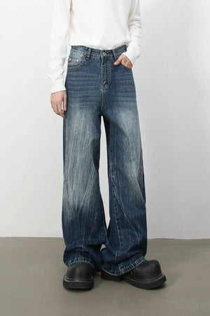 Oversized wash-effect palazzo jeans in medium blue denim with a wide leg and distressed details.