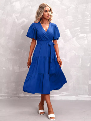Royal blue tiered midi dress with flutter sleeves and wrap neckline, belted waist