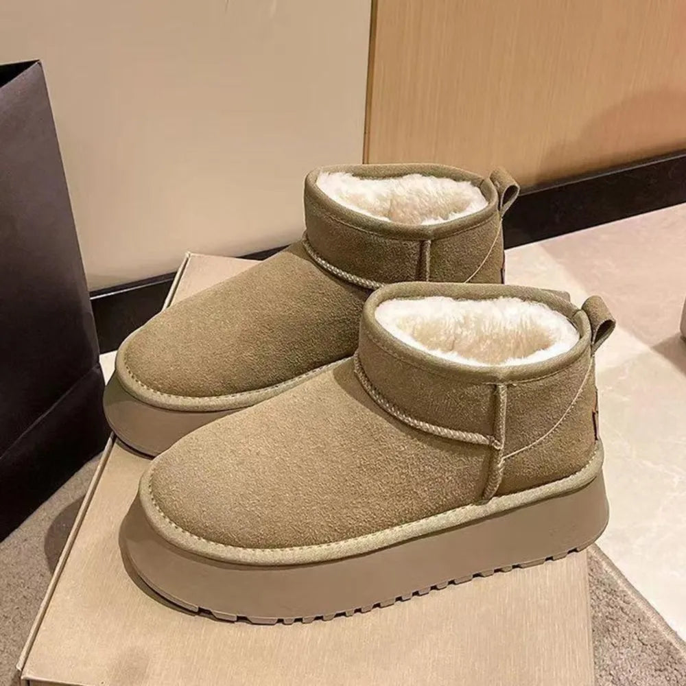 Khaki shearling platform ankle boots with white fluffy lining and pull tabs.