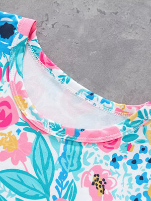 T-shirt with a vibrant floral print, round neckline, and pink trim.