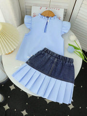 Baby blue ruffled top and denim skirt with pleated hem