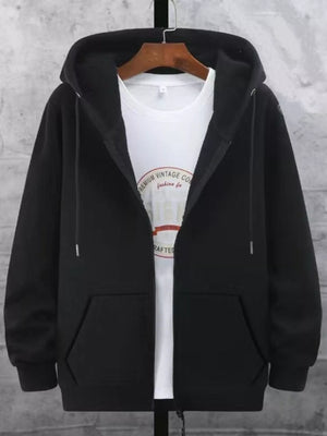 Black fleece-lined zip-up hoodie with front pockets and drawstring hood, worn over a white graphic tee.