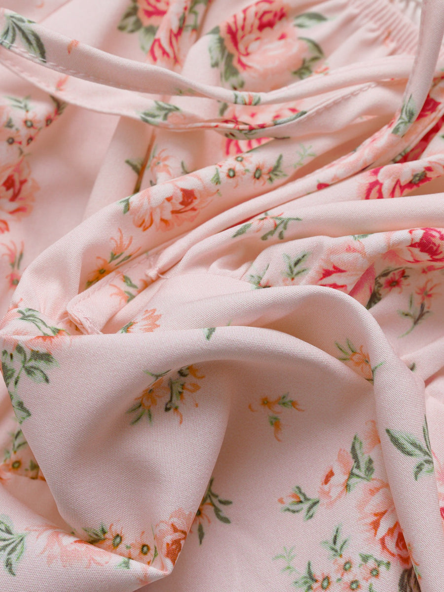 Pink floral tie front puff sleeve blouse with a cropped length.