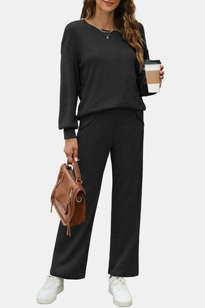 Black ribbed knit loungewear set with crew neck top and wide leg pants.