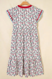 Vibrant floral midi dress with tiered hem, short sleeves, and contrast trim.