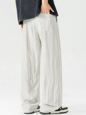 Lightweight wide-leg trousers in light gray with a drawstring waist and pockets.
