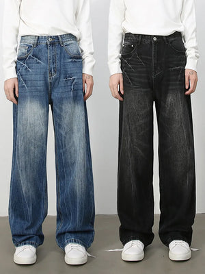 Wide-leg distressed denim jeans in vintage wash dark and medium colors with frayed details.