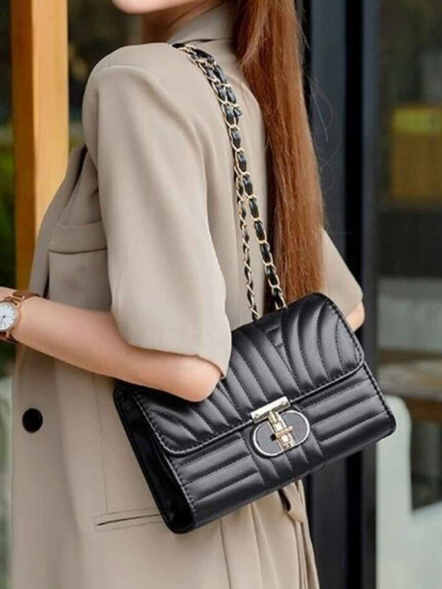 black crossbody bag with turn-lock and quilted