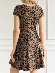 Leopard print cotton mini dress with short sleeves and a flared skirt.
