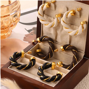 Braided leather hoop earrings with gold accents in black, coffee brown, and white.