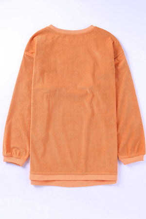Orange corded long sleeve sweatshirt with ribbed texture and crew neck.